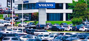 Rows of used vehicles parked on a car dealership lot, the kind of dealer-advertised listings used as comparable vehicles in a total loss valuation report