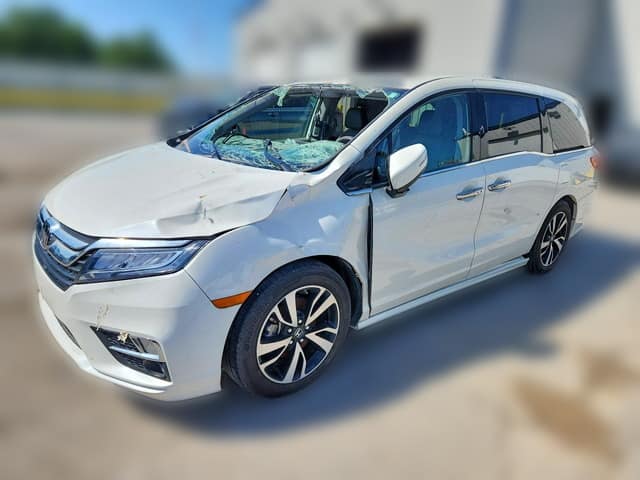 White 2019 Honda Odyssey Elite minivan with a crumpled hood and shattered windshield after a front-end collision